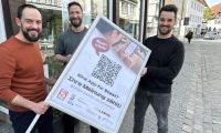 Stephan Siegert und Helge Ernst von der Stadt Soest halten zusammen mit Dennis Wiosna von SWCode ein Plakat zur Teilnahme an der SoestApp-Umfrage hoch.
